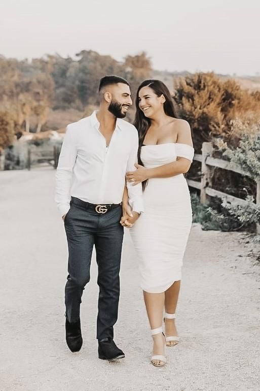 Woman wearing a figure flattering Zia Bodycon Wrap Midi Dress - Pearl White Bodycon Collection