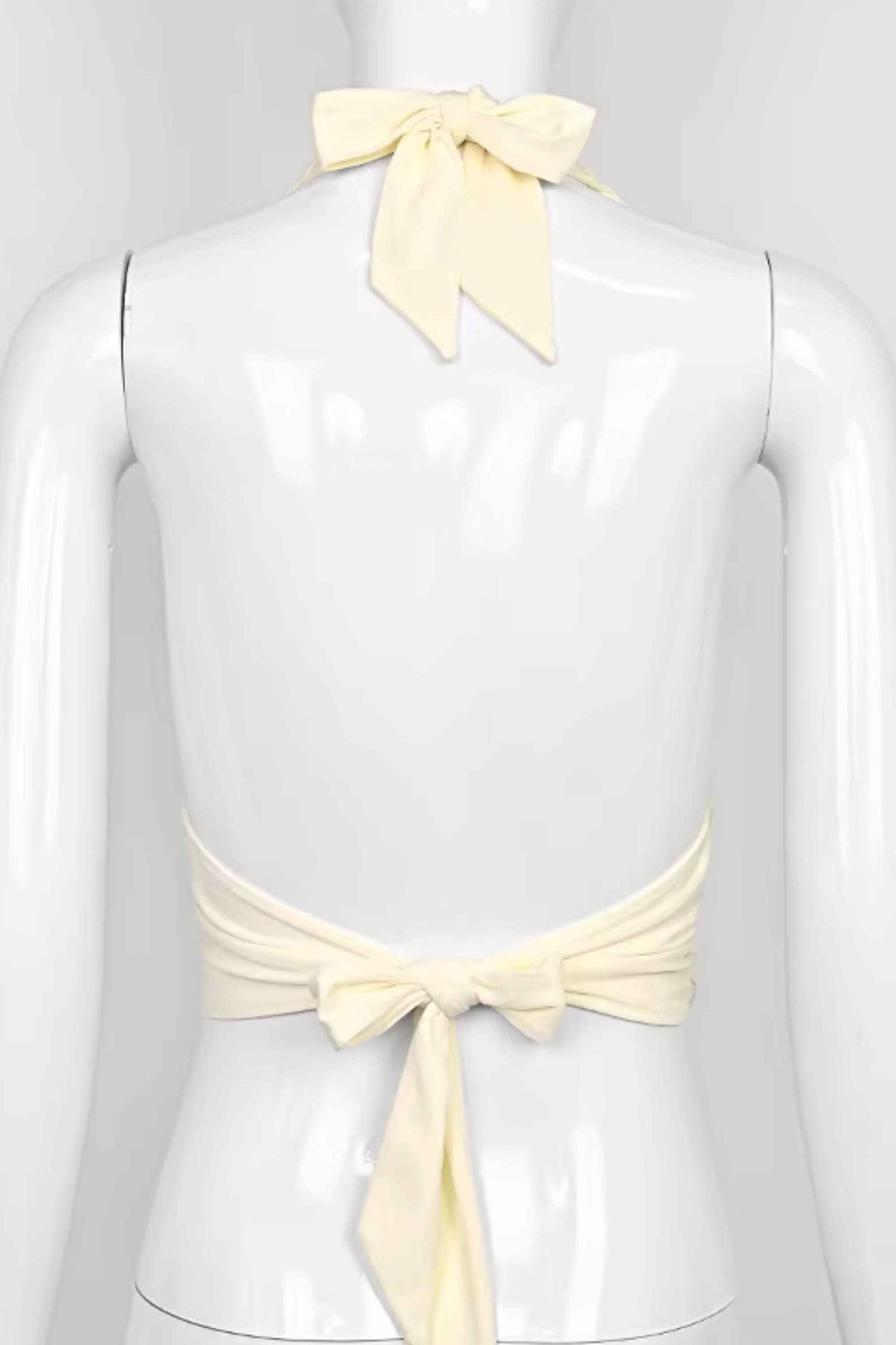 Woman wearing a figure flattering  Aby Halter Top - Butter Yellow BODYCON COLLECTION Pty Ltd