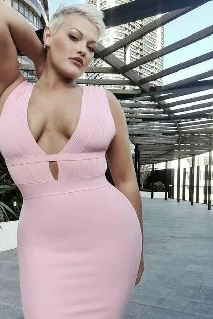 Woman wearing a figure flattering  Bay Bandage Dress - Ballet Pink Bodycon Collection