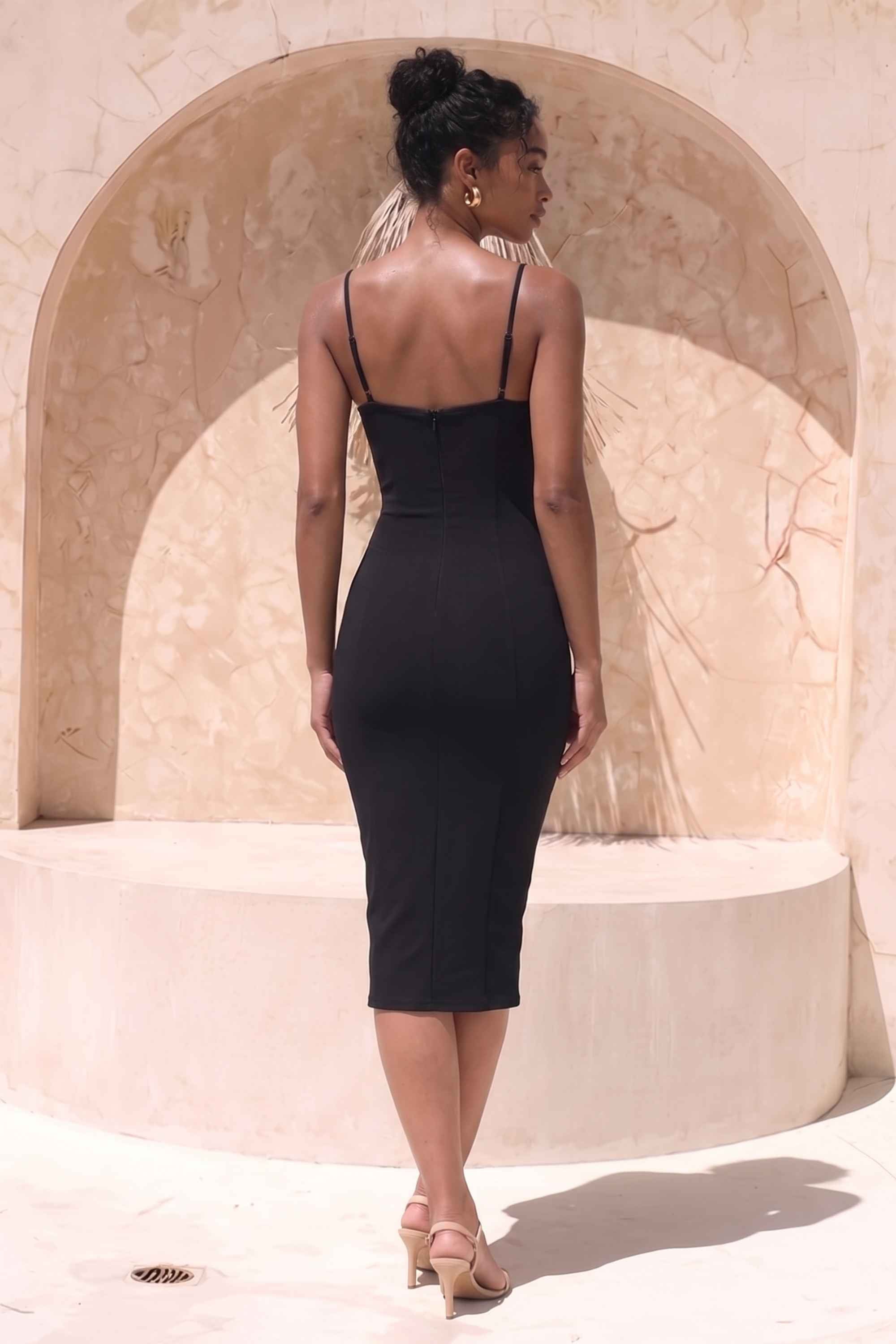 Woman wearing a figure flattering  Blanche Bandage Midi Dress - Classic Black BODYCON COLLECTION
