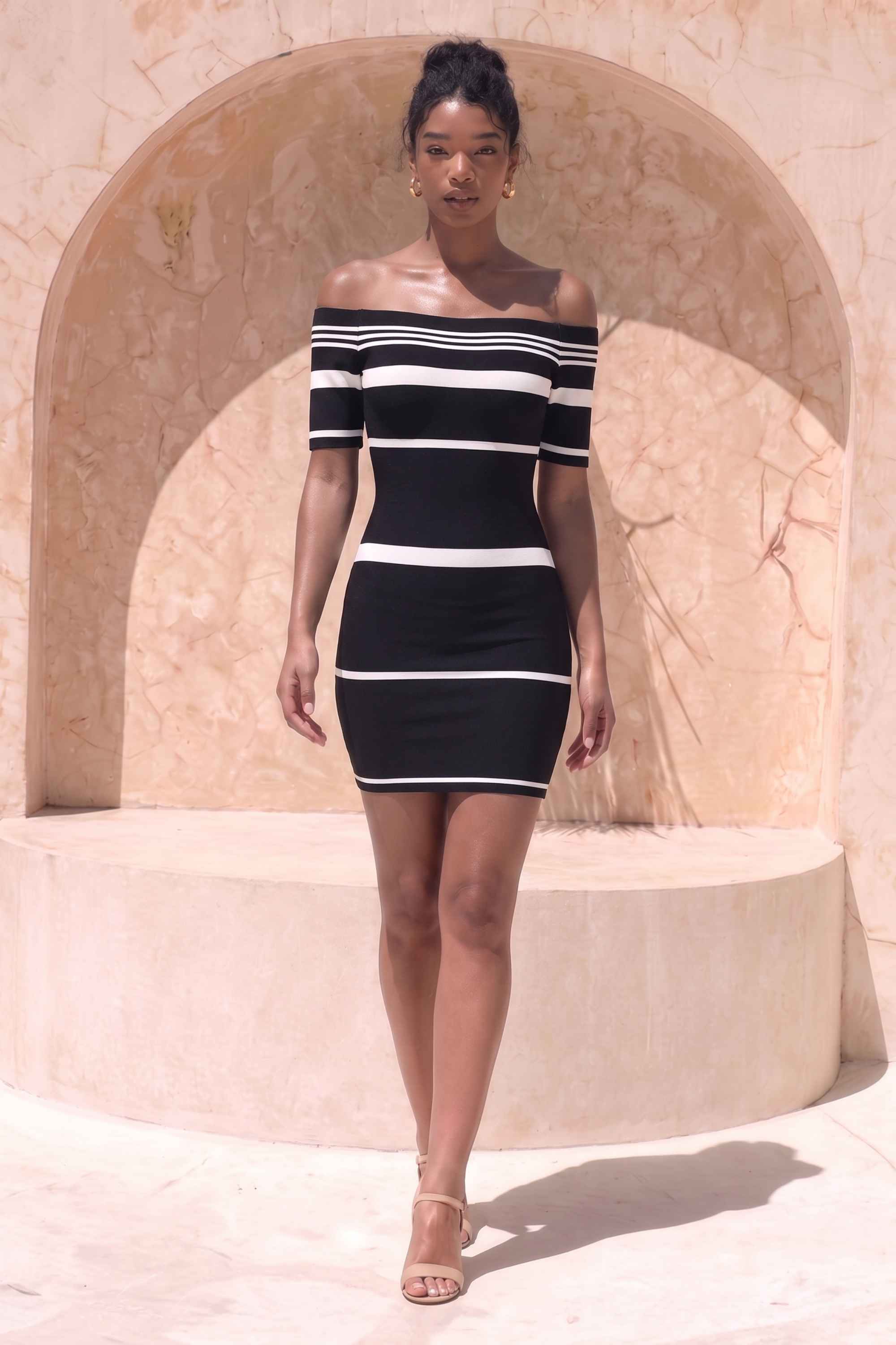Woman wearing a figure flattering  Evelyn Bandage Mini Dress - Classic Black BODYCON COLLECTION Pty Ltd