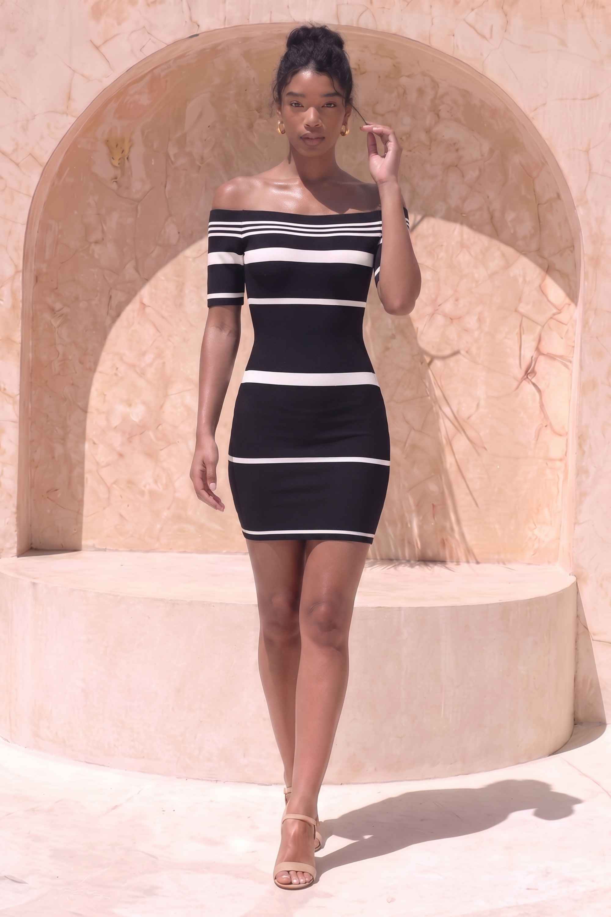 Woman wearing a figure flattering  Evelyn Bandage Mini Dress - Classic Black BODYCON COLLECTION Pty Ltd