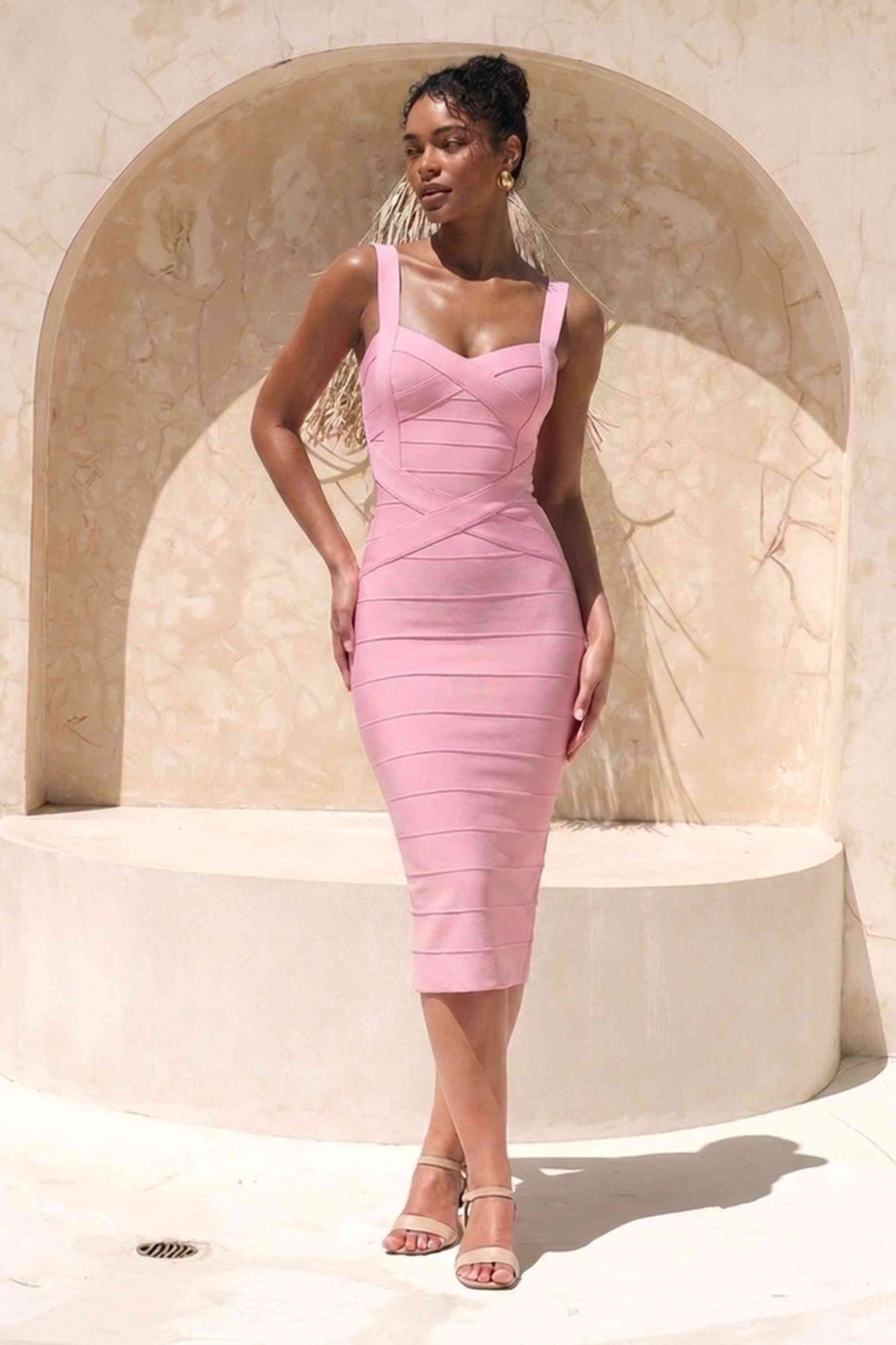 Woman wearing a dusty pink party dress Heidi Bandage Midi Dress - Dusty Pink Bodycon Collection