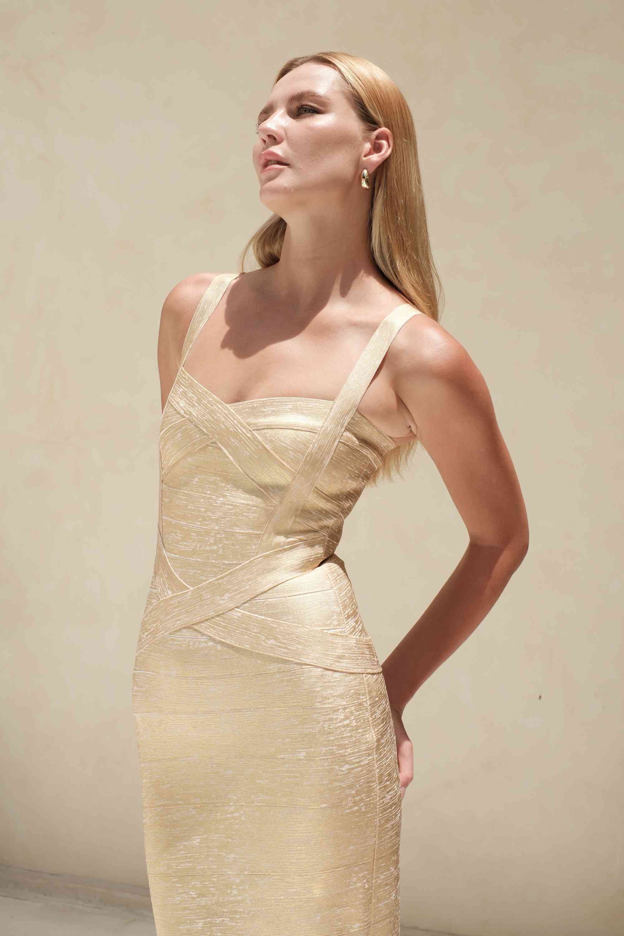 Woman wearing a figure flattering  Heidi Bandage Midi Dress - Gold BODYCON COLLECTION