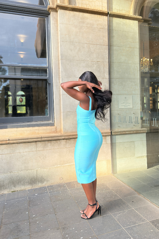 Woman wearing a figure flattering  Heidi Bandage Midi Dress - Sky Blue Bodycon Collection