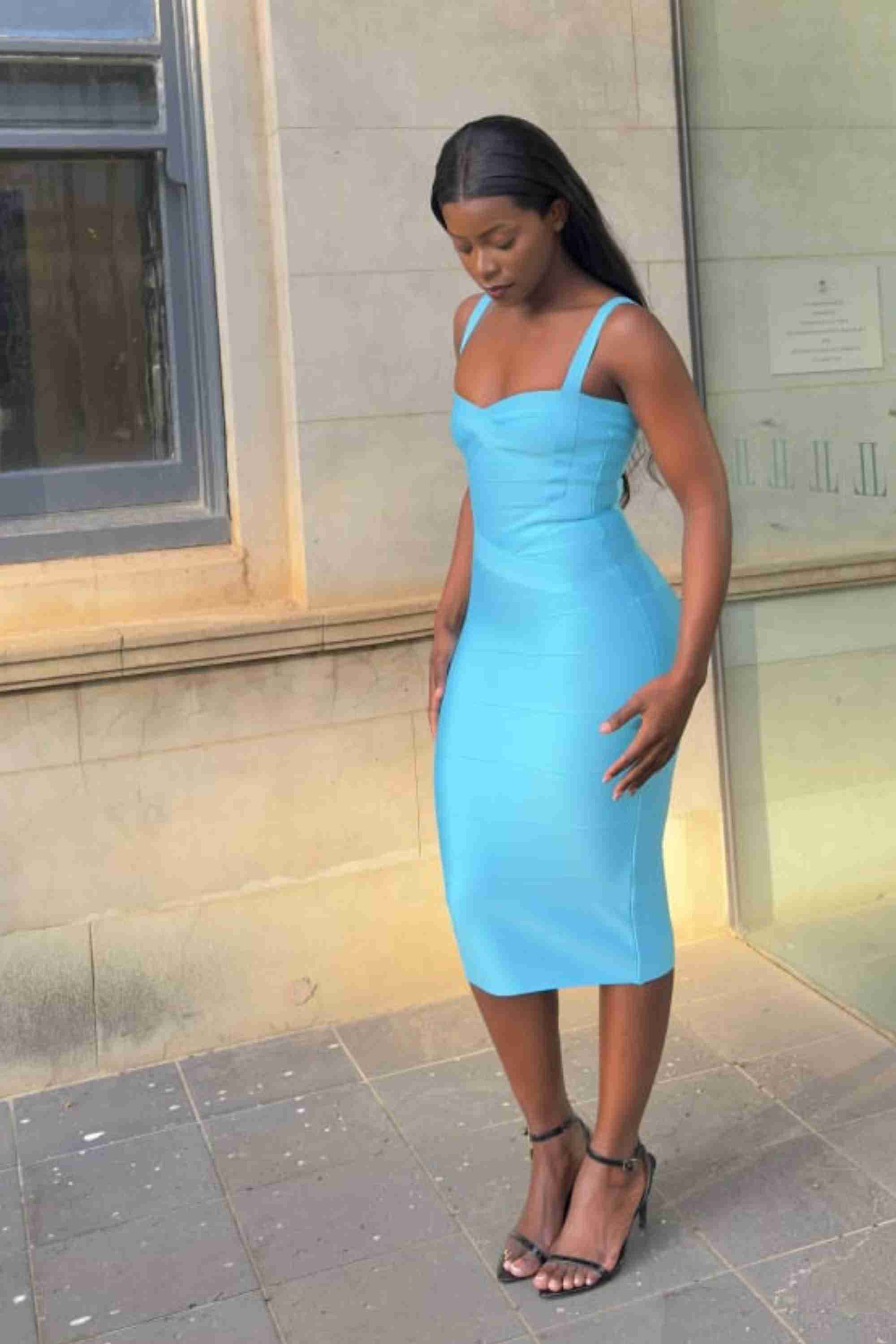 Woman wearing a figure flattering  Heidi Bandage Midi Dress - Sky Blue Bodycon Collection