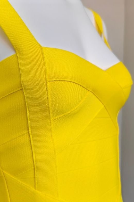 Woman wearing a figure flattering  Heidi Bandage Midi Dress - Sun Yellow Bodycon Collection