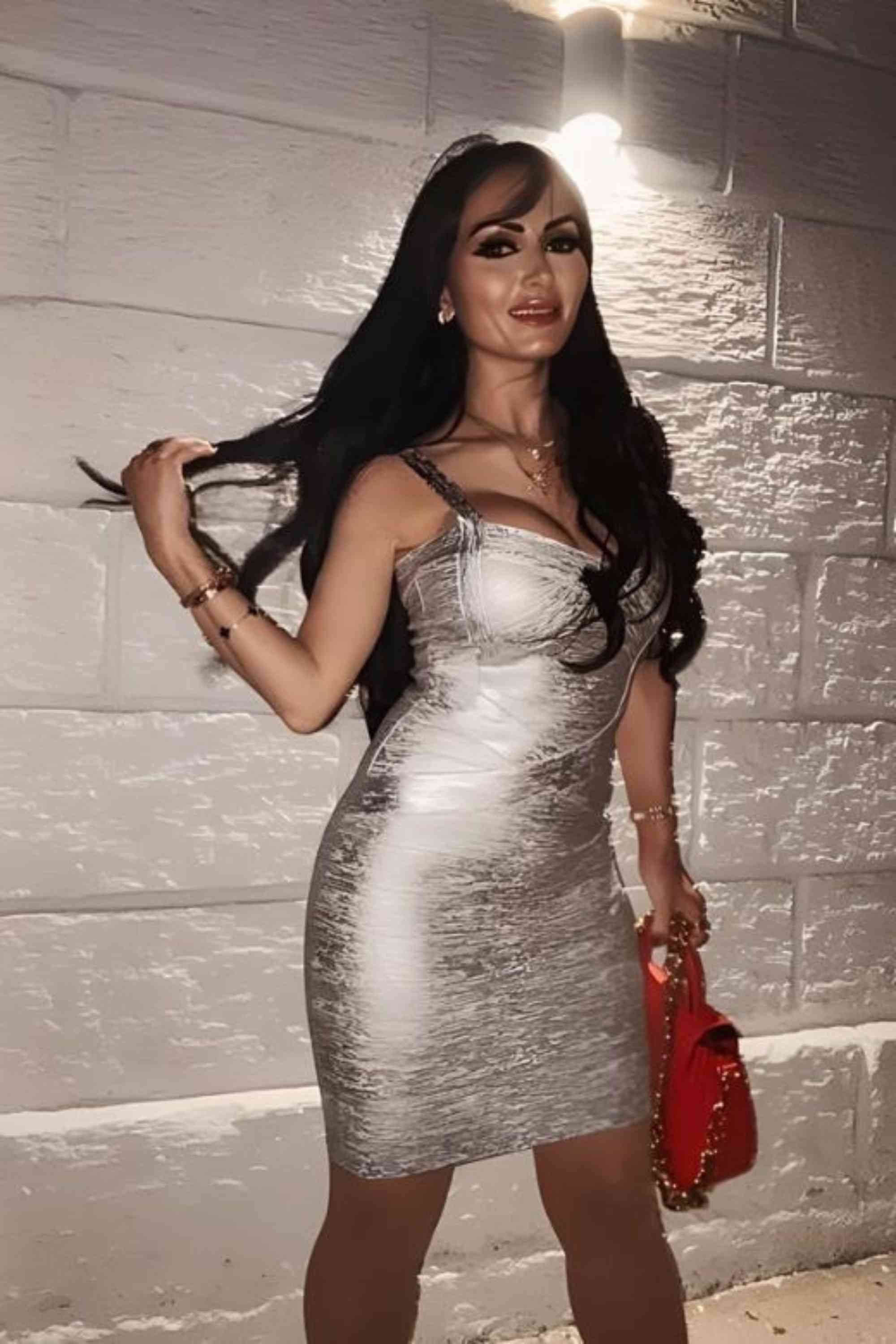 Woman wearing a figure flattering  Heidi Bandage Mini Dress - Silver Bodycon Collection