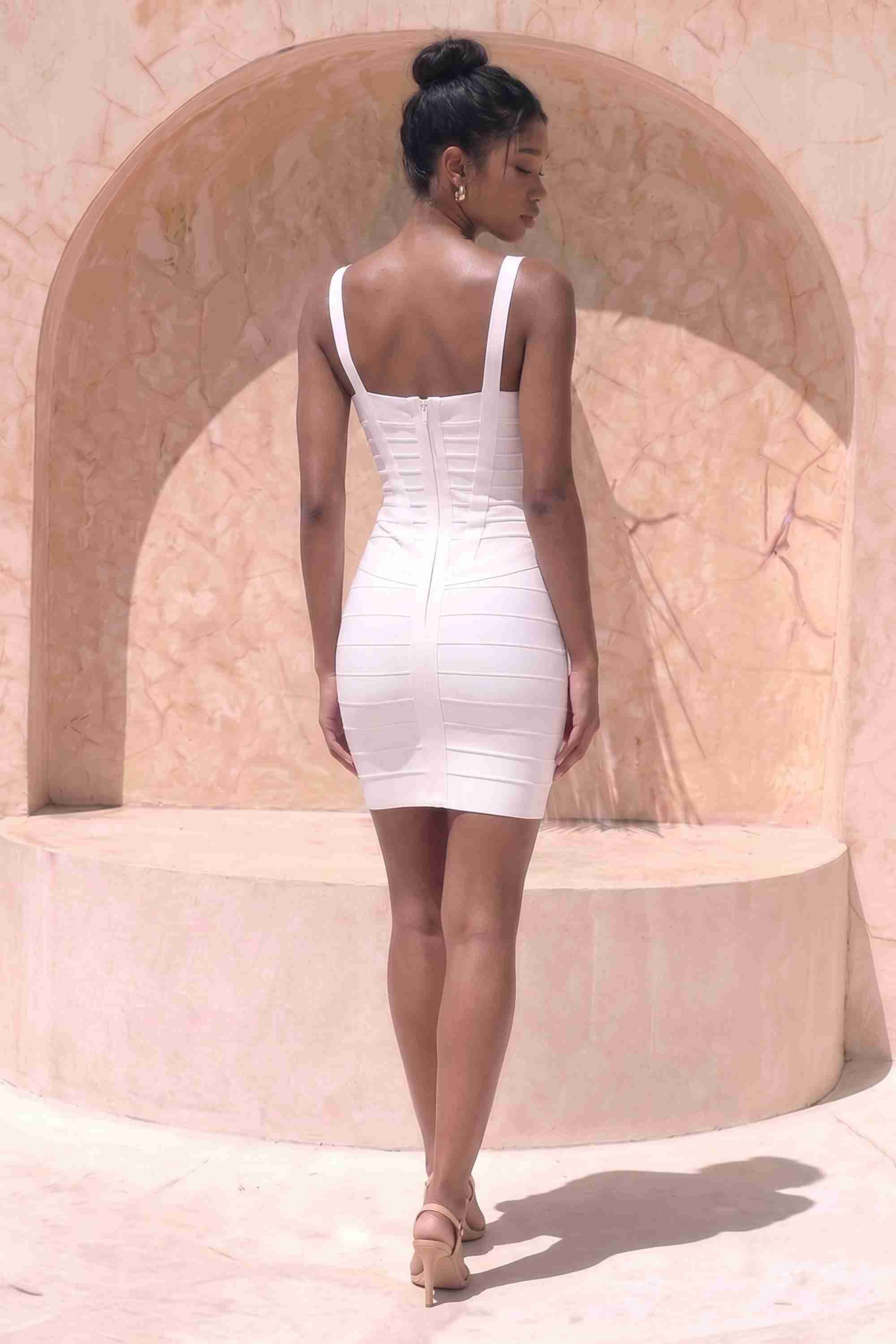Woman wearing a figure flattering  Heidi Bandage Mini Dress - White Pearl Bodycon Collection