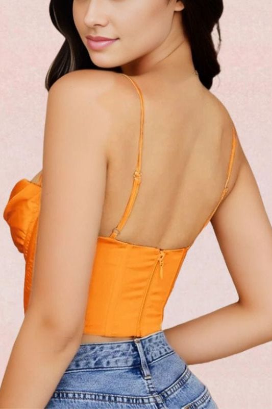 Woman wearing a figure flattering  Indi Corset Crop Top - Apricot Orange BODYCON COLLECTION