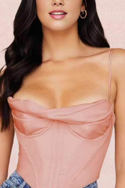 Woman wearing a figure flattering  Indi Corset Crop Top - Dusty Pink BODYCON COLLECTION