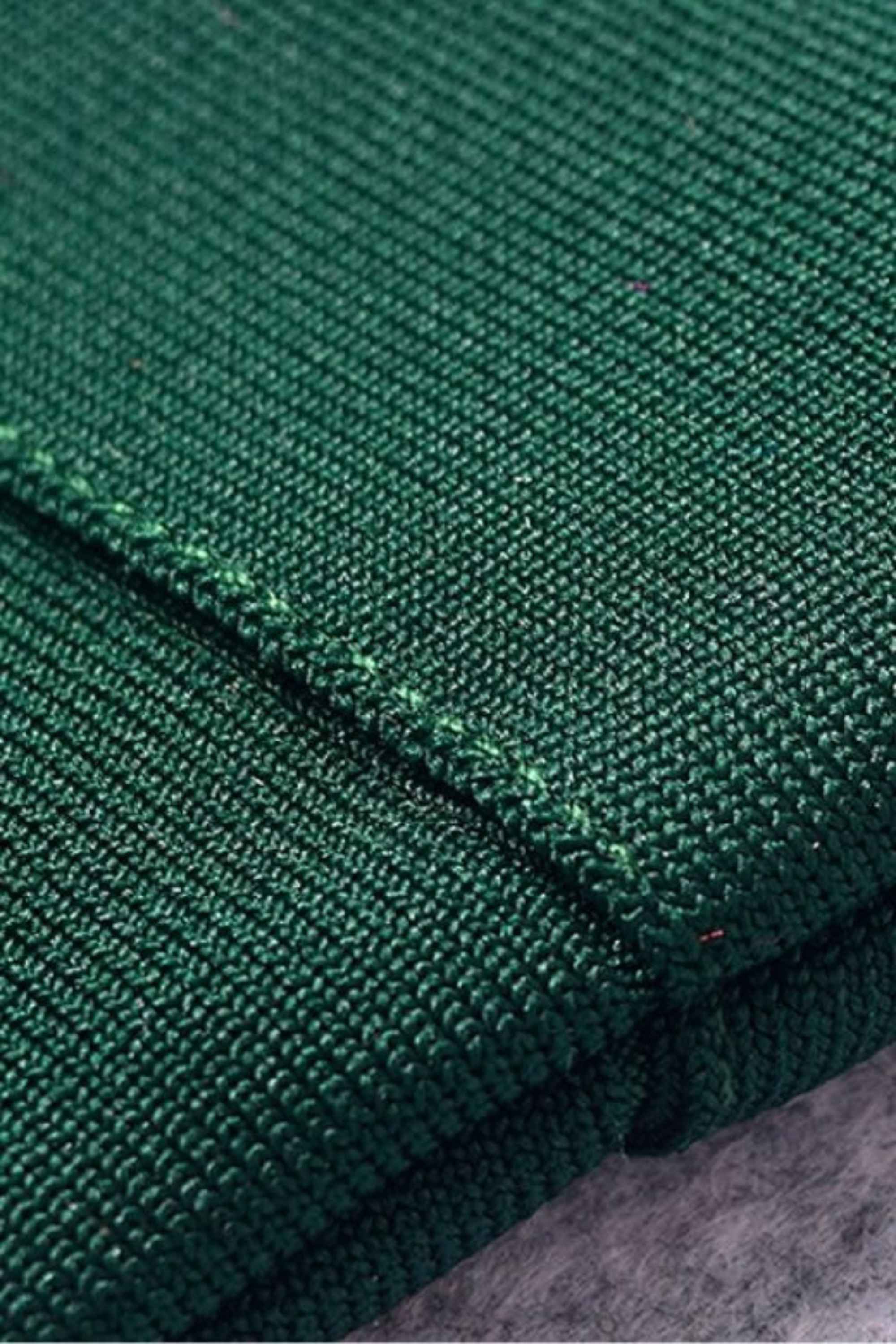 Woman wearing a figure flattering  Josie Bandage V Neck Mini Dress - Emerald Green BODYCON COLLECTION