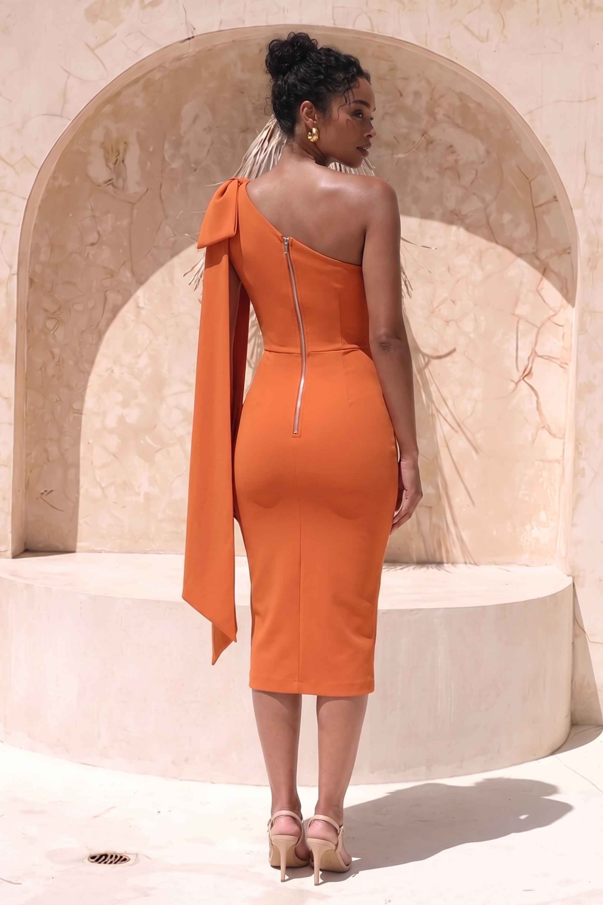 Woman wearing a figure flattering  Lela Long Sleeve Bandage Midi Dress - Apricot Orange BODYCON COLLECTION