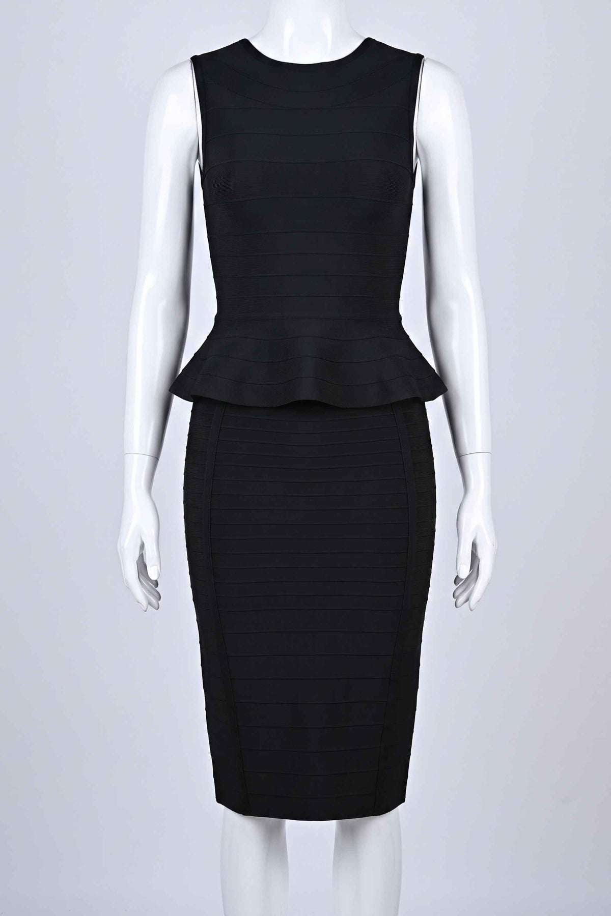 Woman wearing a figure flattering  Leni Bandage Peplum Top - Classic Black BODYCON COLLECTION
