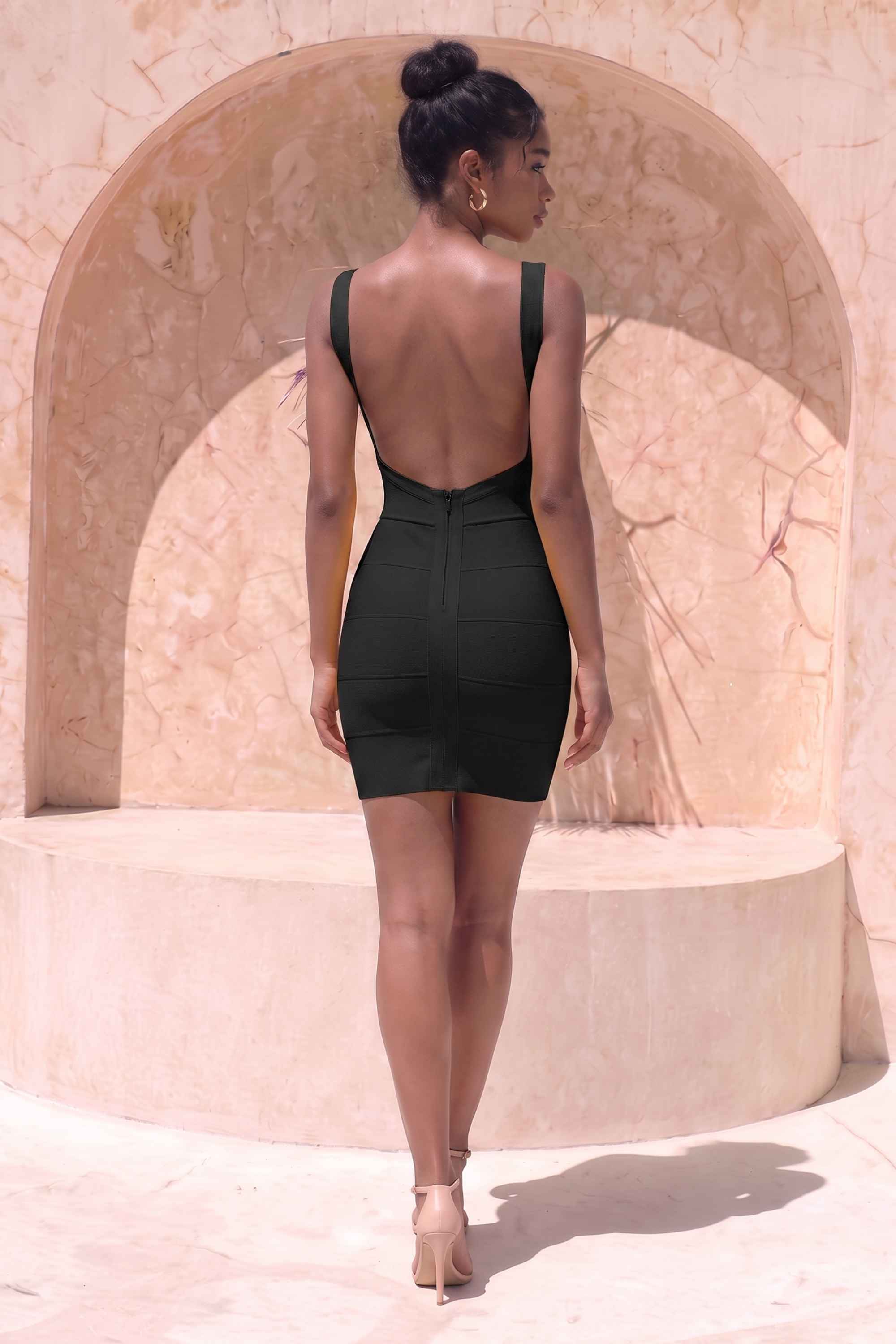 Woman wearing a figure flattering  Maya Bandage Mini Dress - Classic Black BODYCON COLLECTION