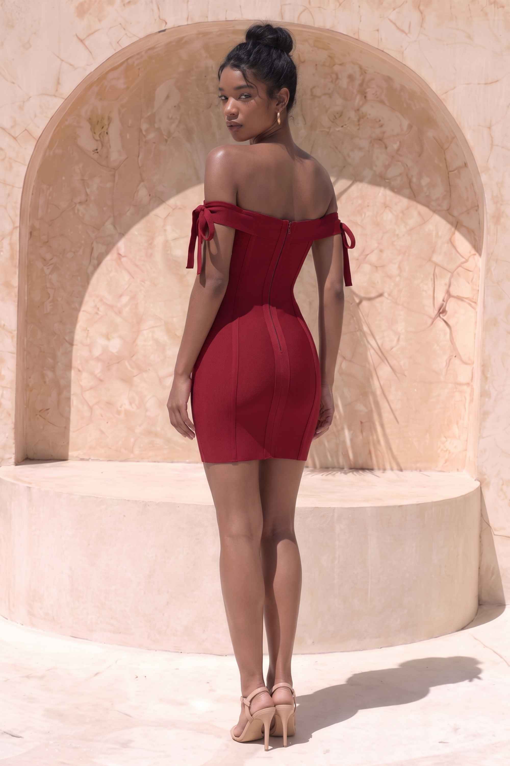 Woman wearing a figure flattering  Penelope Bandage Mini Dress - Red Wine BODYCON COLLECTION