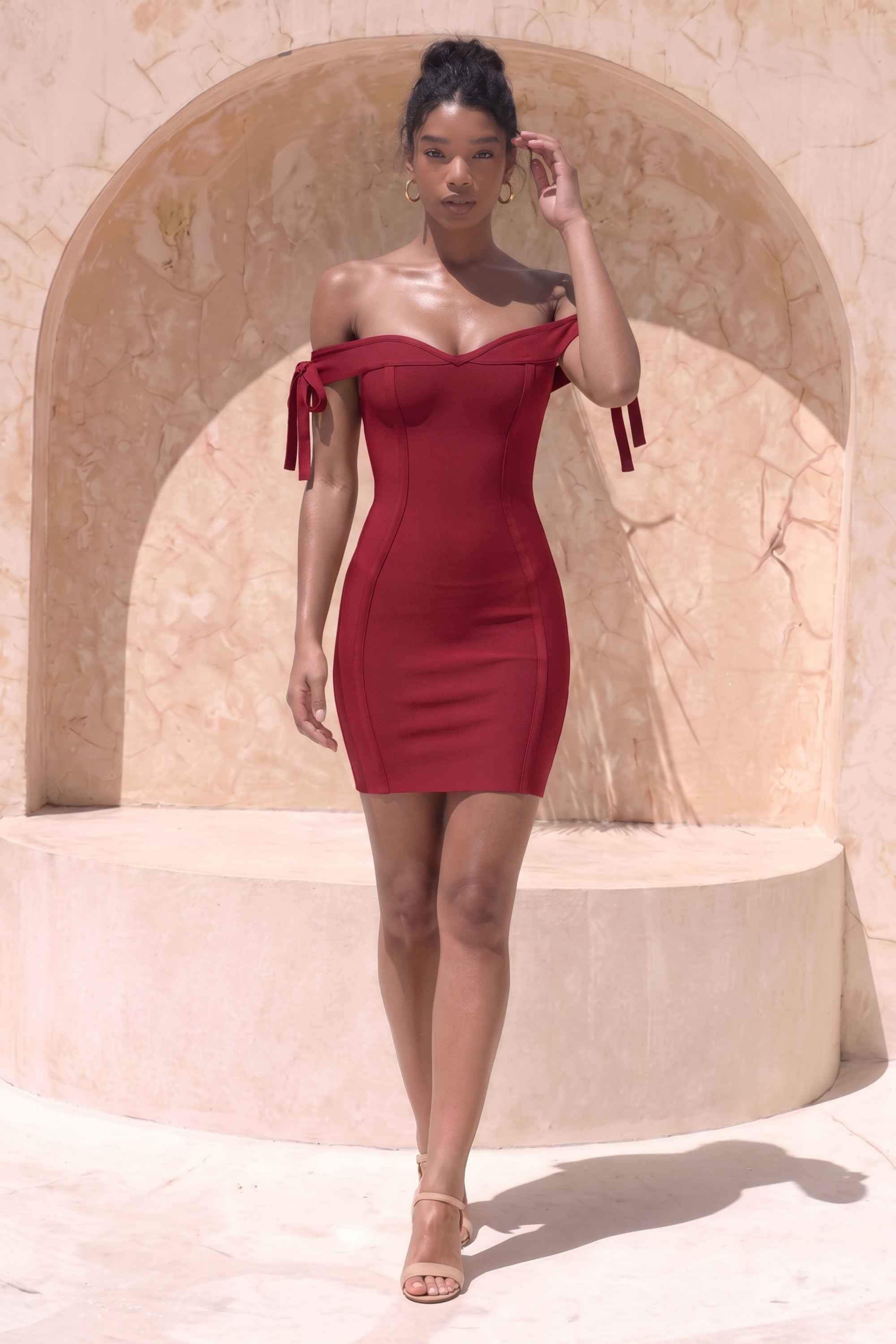 Woman wearing a figure flattering  Penelope Bandage Mini Dress - Red Wine BODYCON COLLECTION