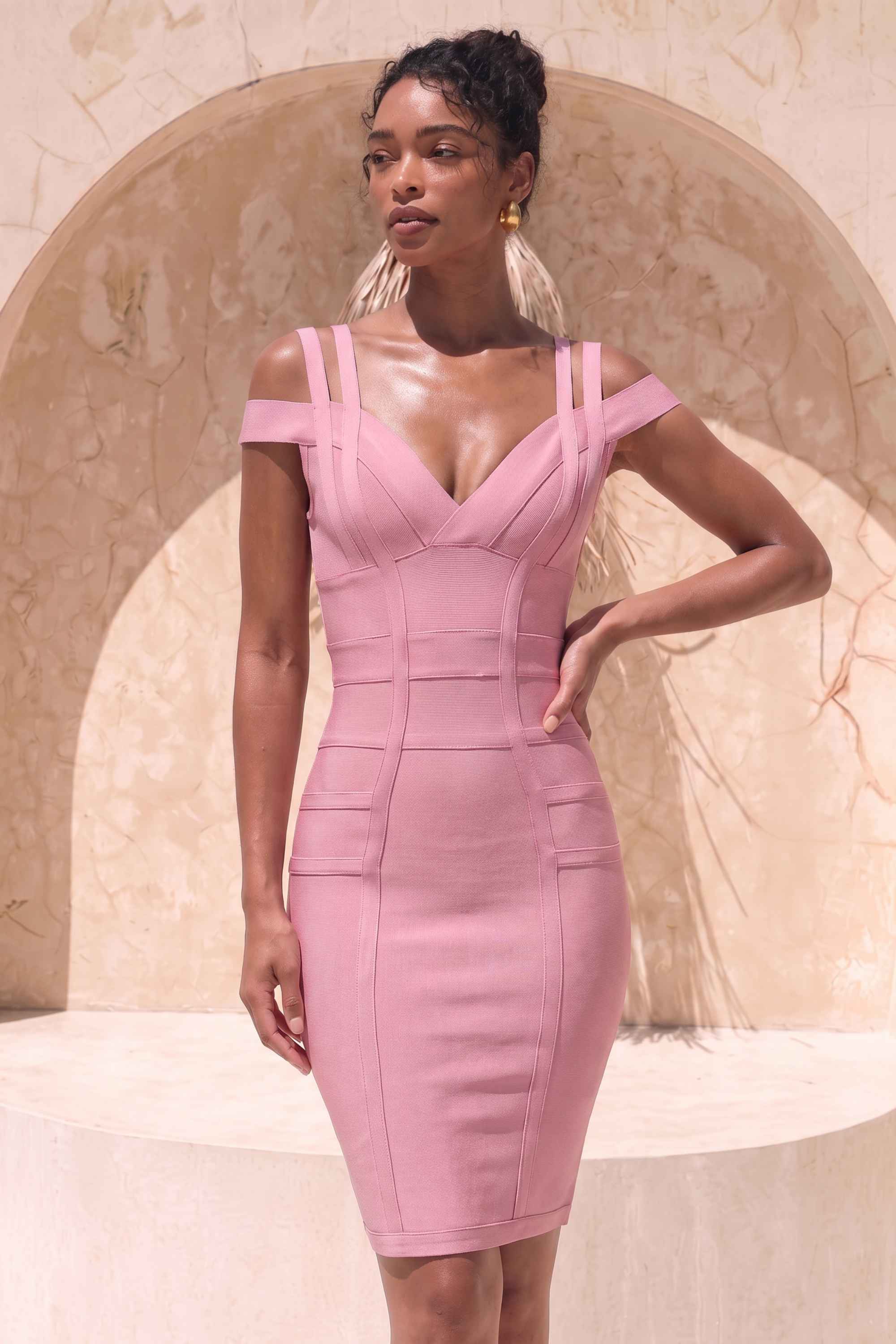 Woman wearing a figure flattering  Sia Bandage Dress - Ballet Pink Bodycon Collection