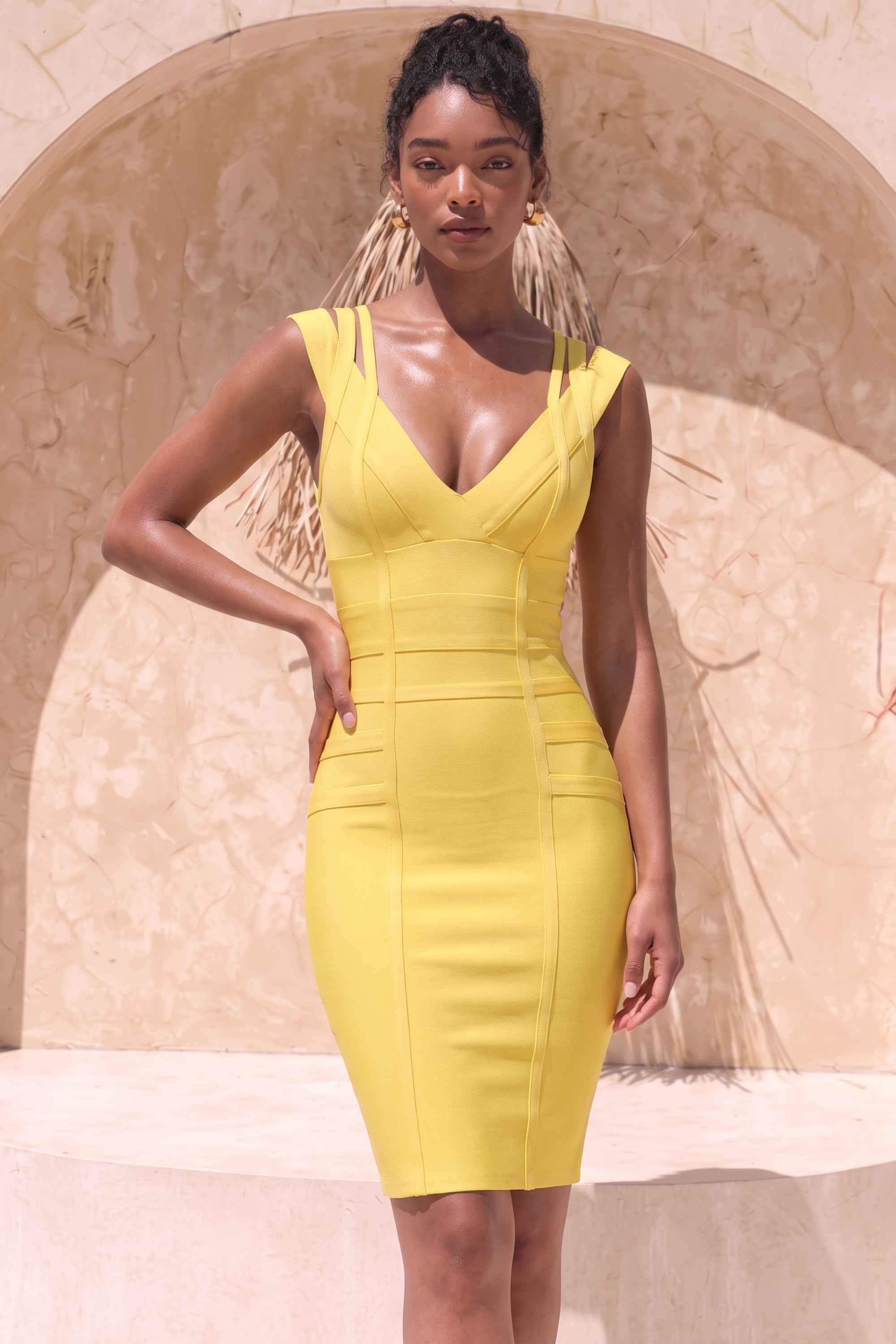 Woman wearing a figure flattering  Sia Bandage Dress - Sun Yellow Bodycon Collection
