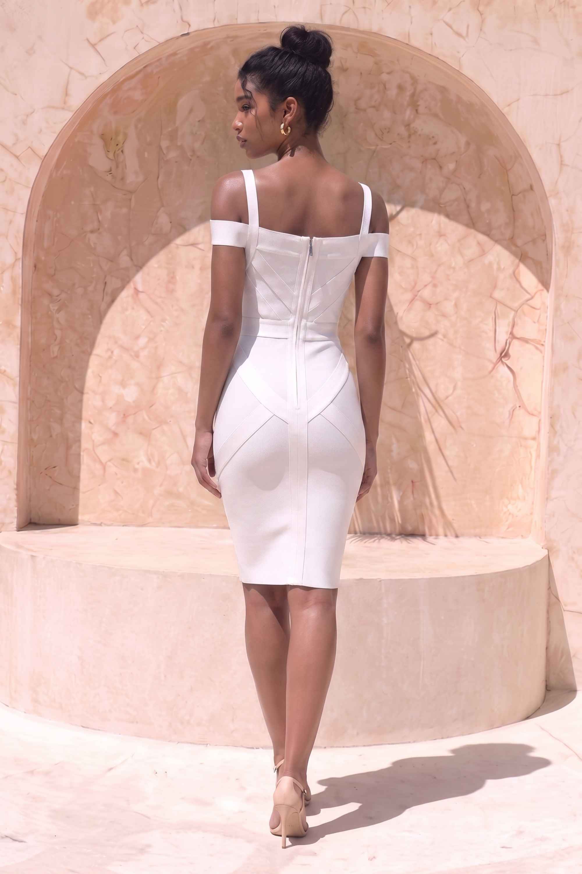 Woman wearing a figure flattering  Sophia Bandage Dress - White Pearl Bodycon Collection